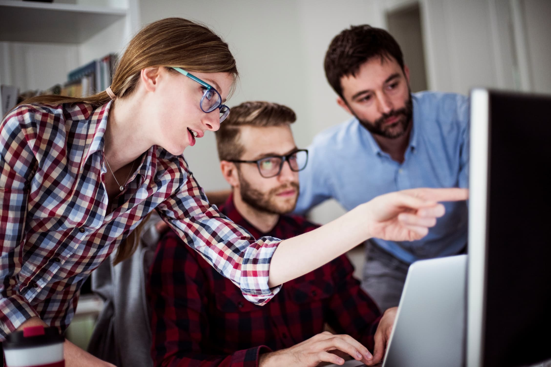 an image of planning experts discussing on a topic while paying attention to a computer screen